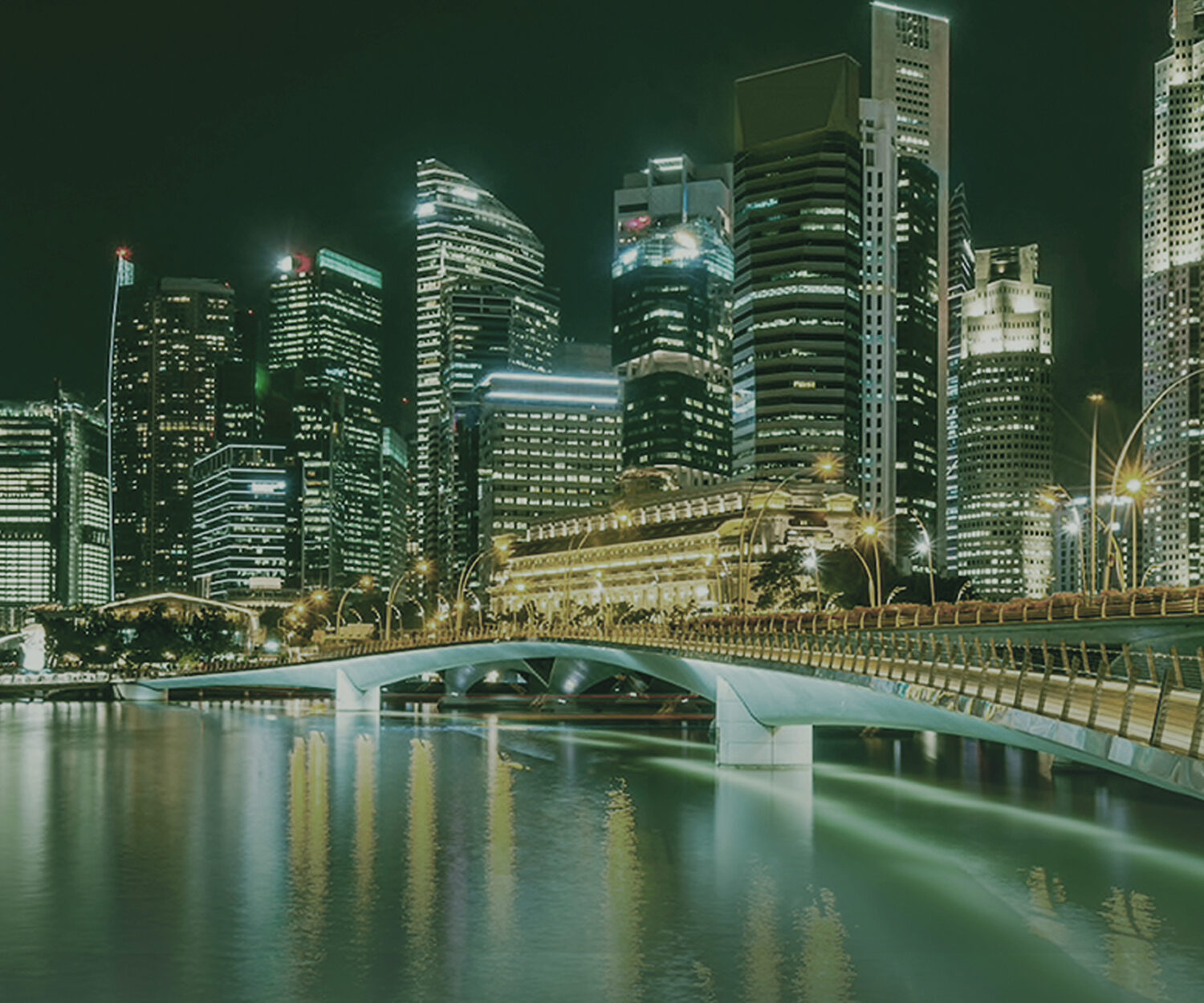 bridge leading to city all lit up