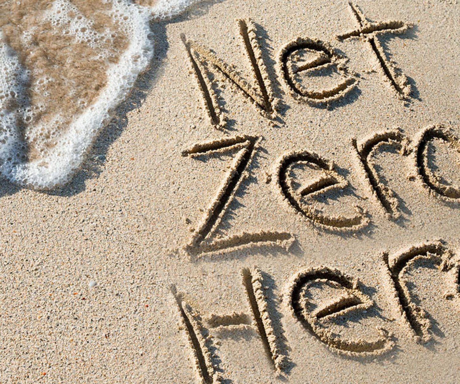 net zero hero drawn in sand