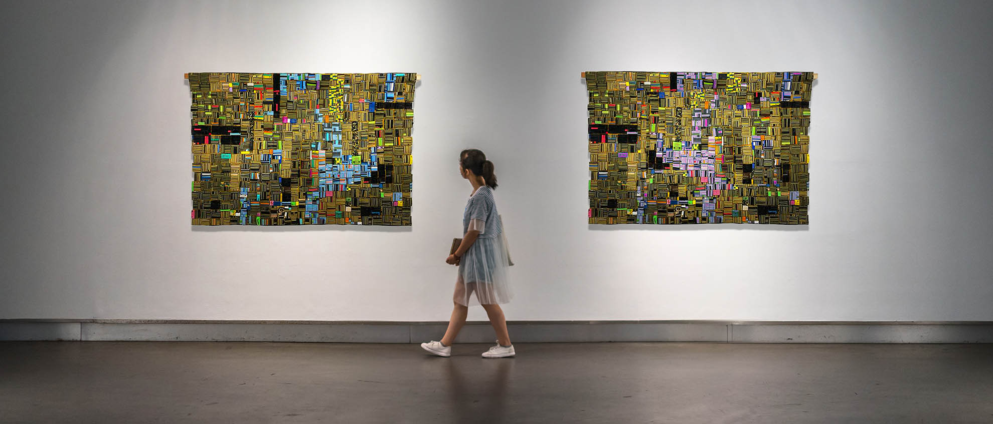 Girl looking at waste to art exhibits in gallery